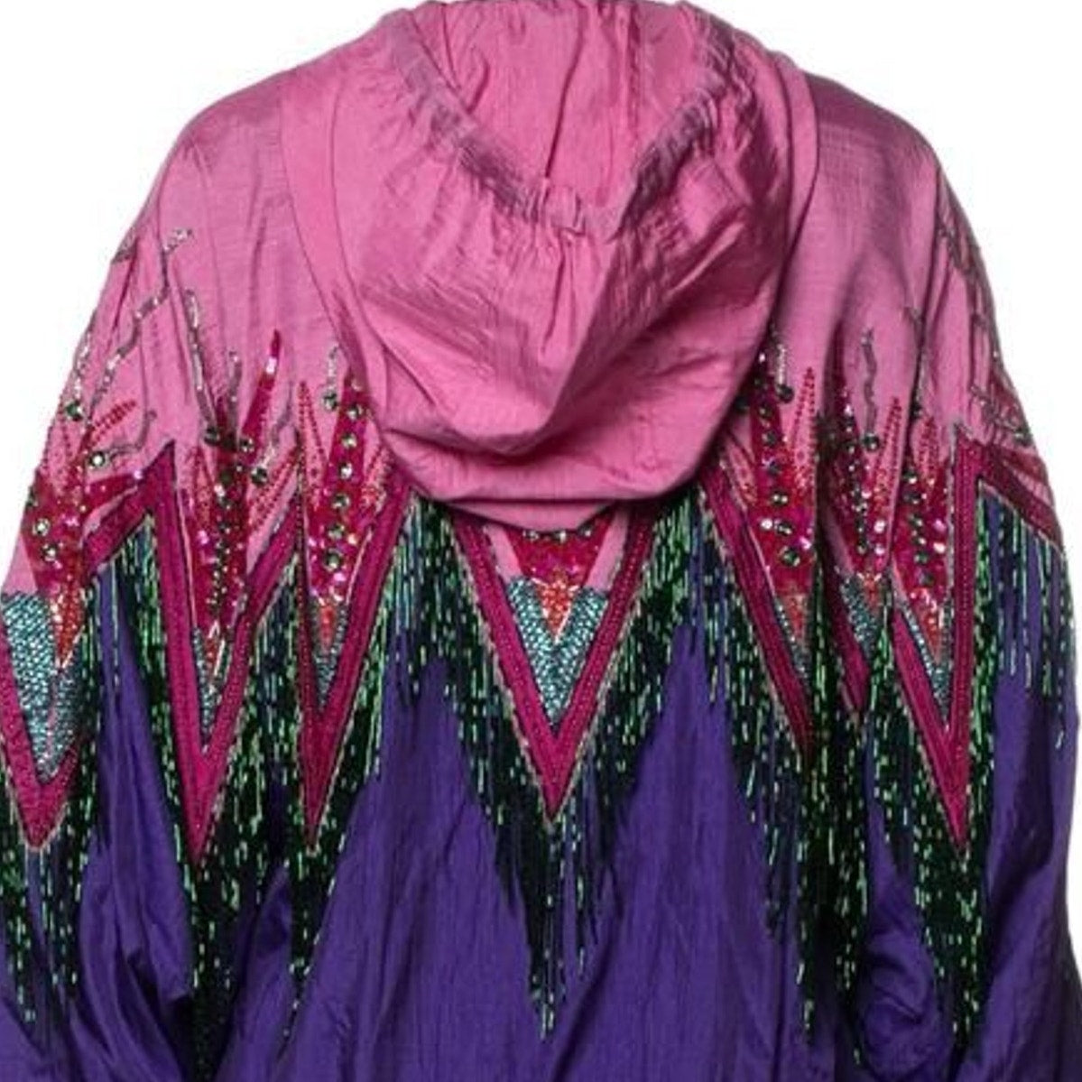 A pink and purple hooded jacket with intricate geometric beadwork and fringe details, shown against a plain white background.